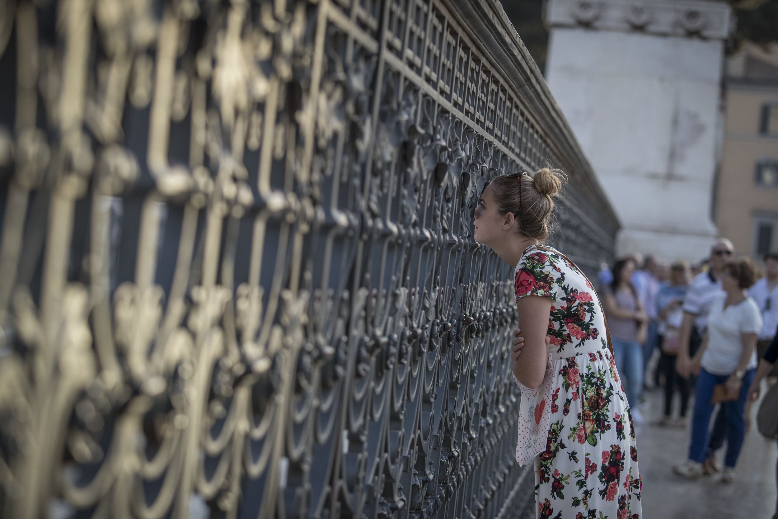 Temple Rome student peeks through a historic Roman gate