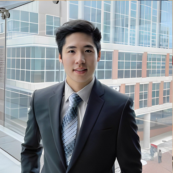 Huang pictured in a suit on campus