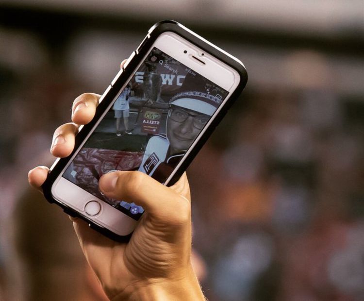 A band member takes a selfie with Stella