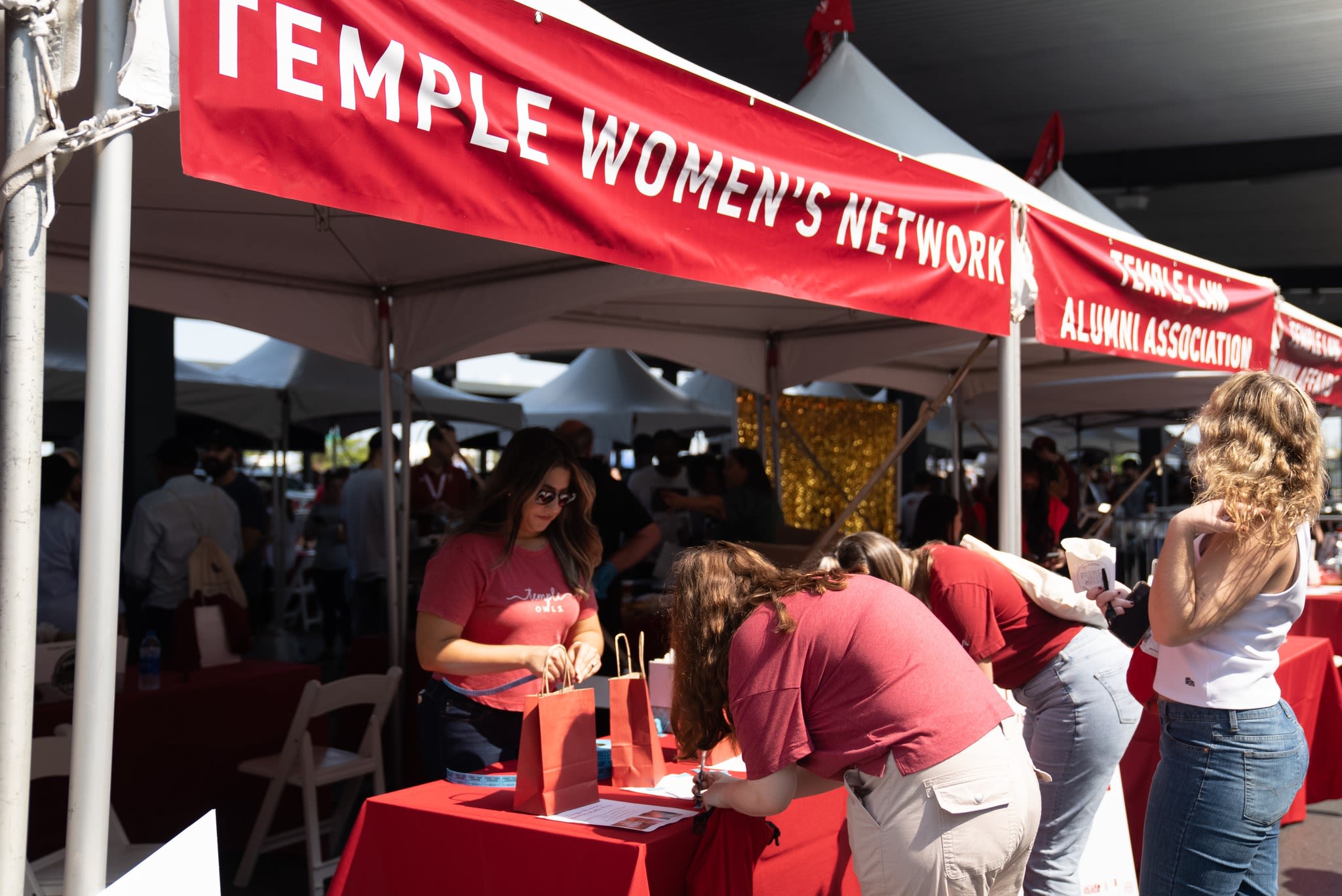 The members of TWNstand in front of Homecoming booth